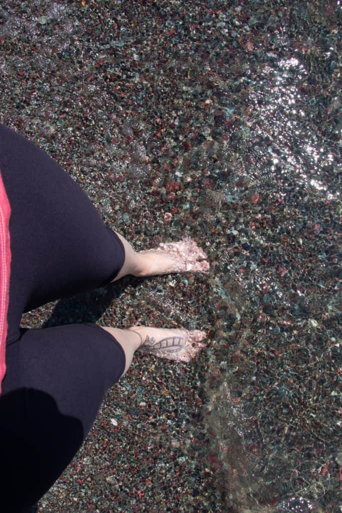 Feet in the water of Saint Mary Lake in Glacier National Park